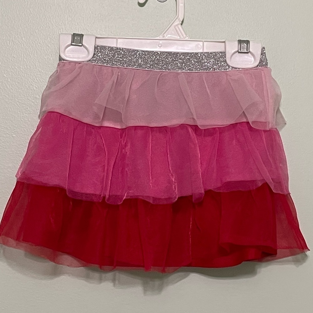 Cute size 4T skirt with layers of pinks and red with a silver sparkly waist band